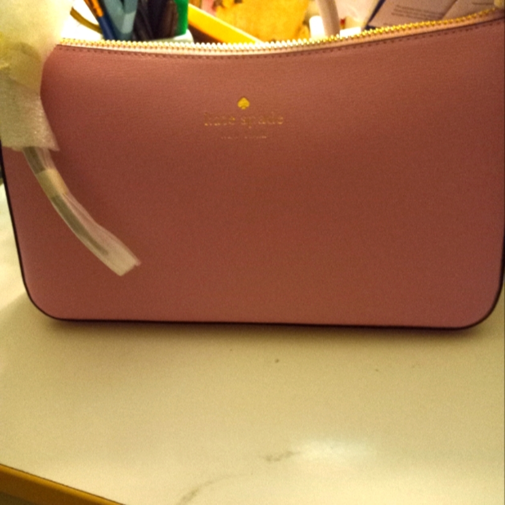 New,with tag Kate Spade pink crossbody soft pvc bag with 24inch length strap.
